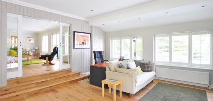 Spacious and bright modern living room with wooden floors and stylish furniture.