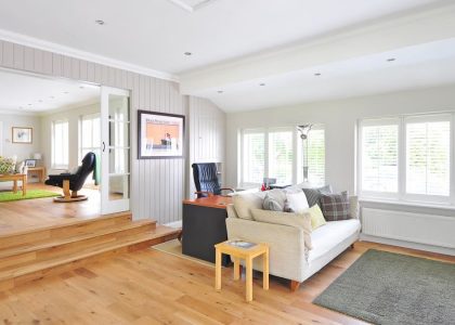 Spacious and bright modern living room with wooden floors and stylish furniture.